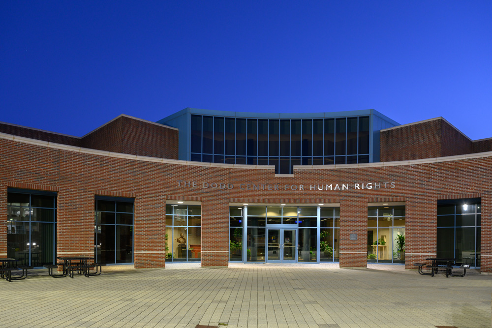 The Dodd Center for Human Rights building at night.