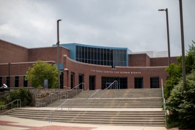 The Dodd Center for Human Rights building from a distance with a set of cement stairs leading up to it. 