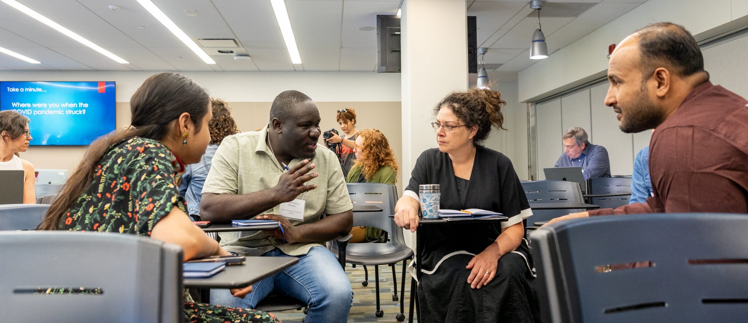 Participants of the Summer Seminar for Genocide Studies and Prevention engage in discussion during a session in Bousfield Building.
